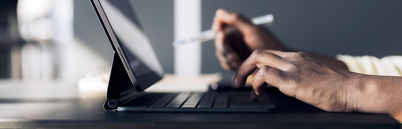 A closeup of someone typing on a laptop