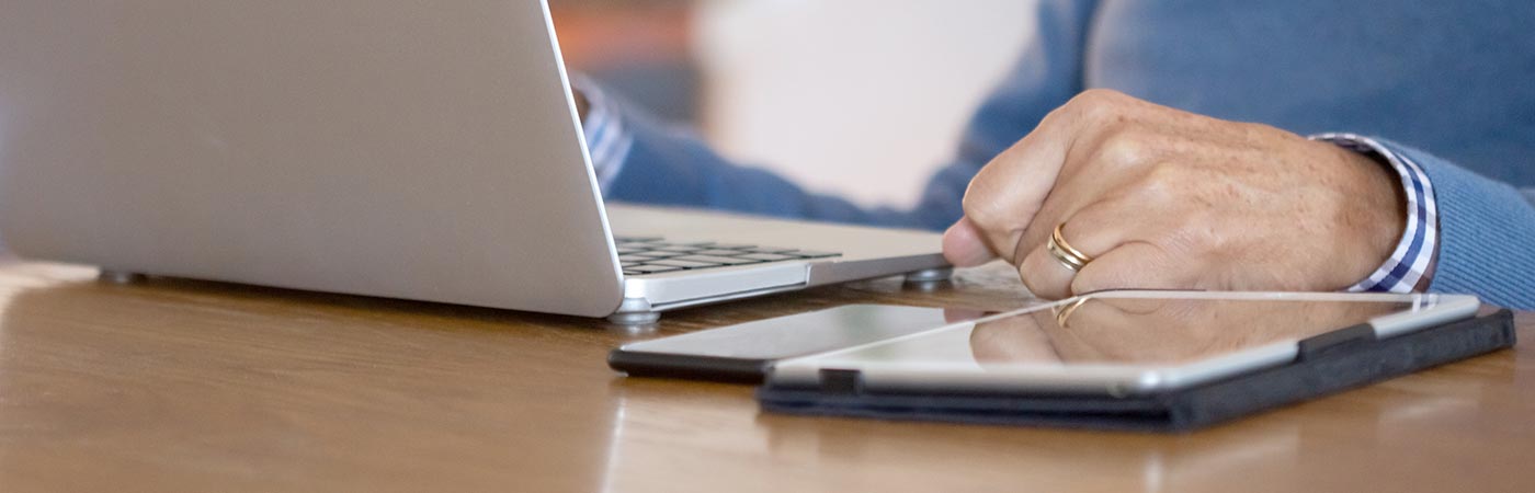 A man uses a computer on a desk