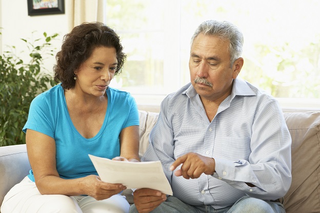 Couple sitting on sofa and holding the form