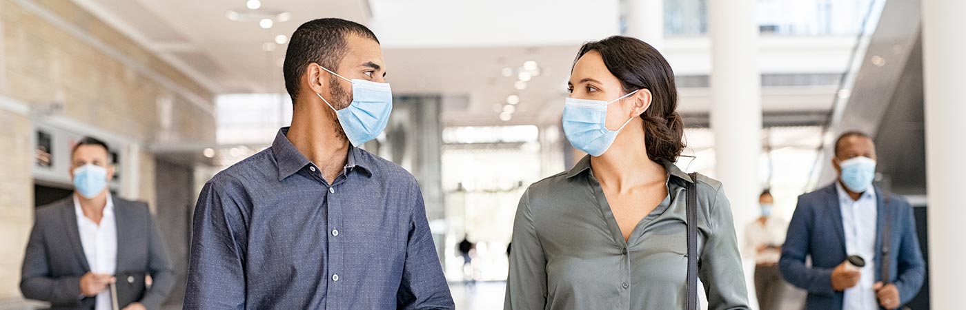 A group walks in a building with masks