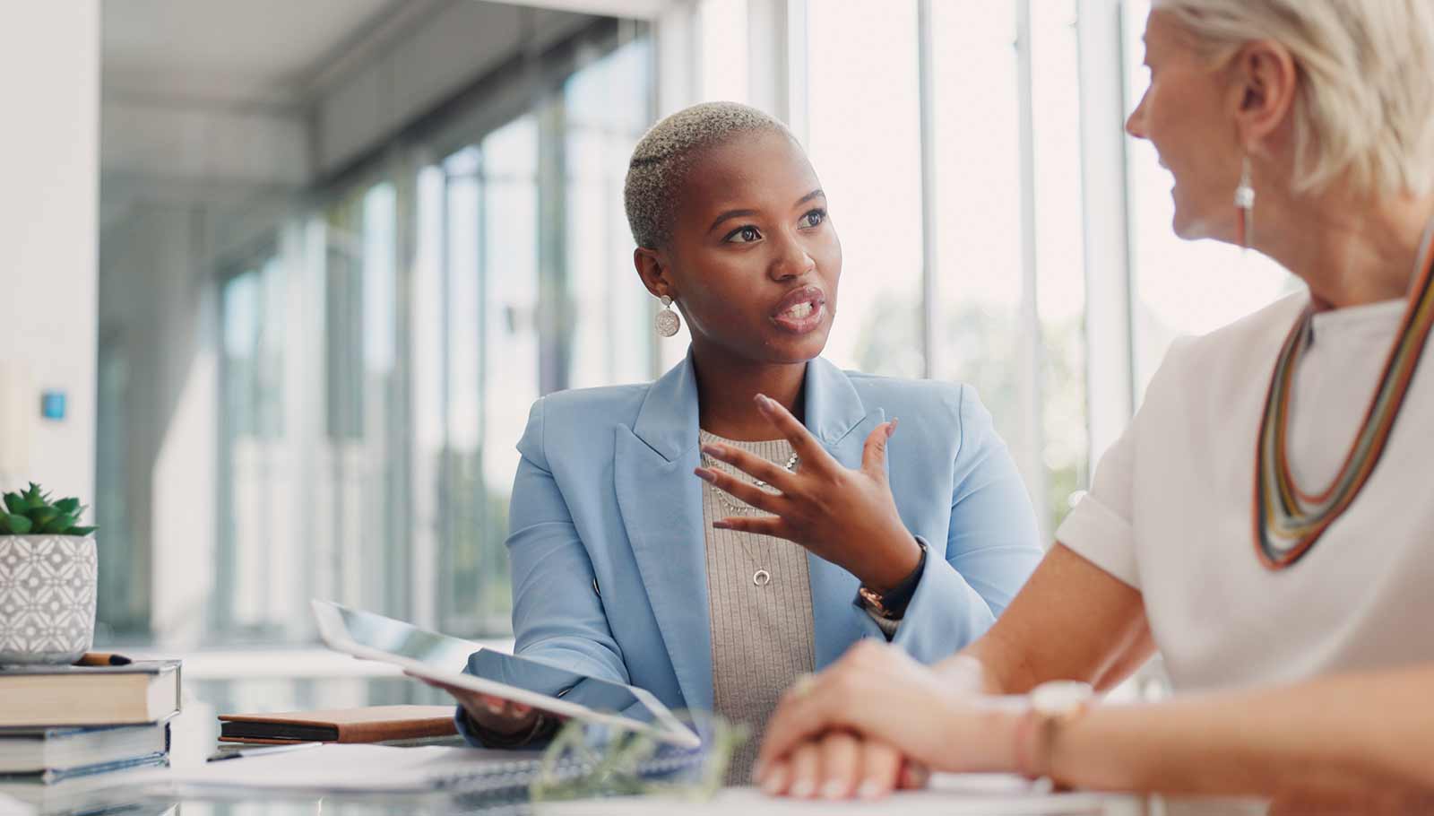 Two blonde women having a conversation